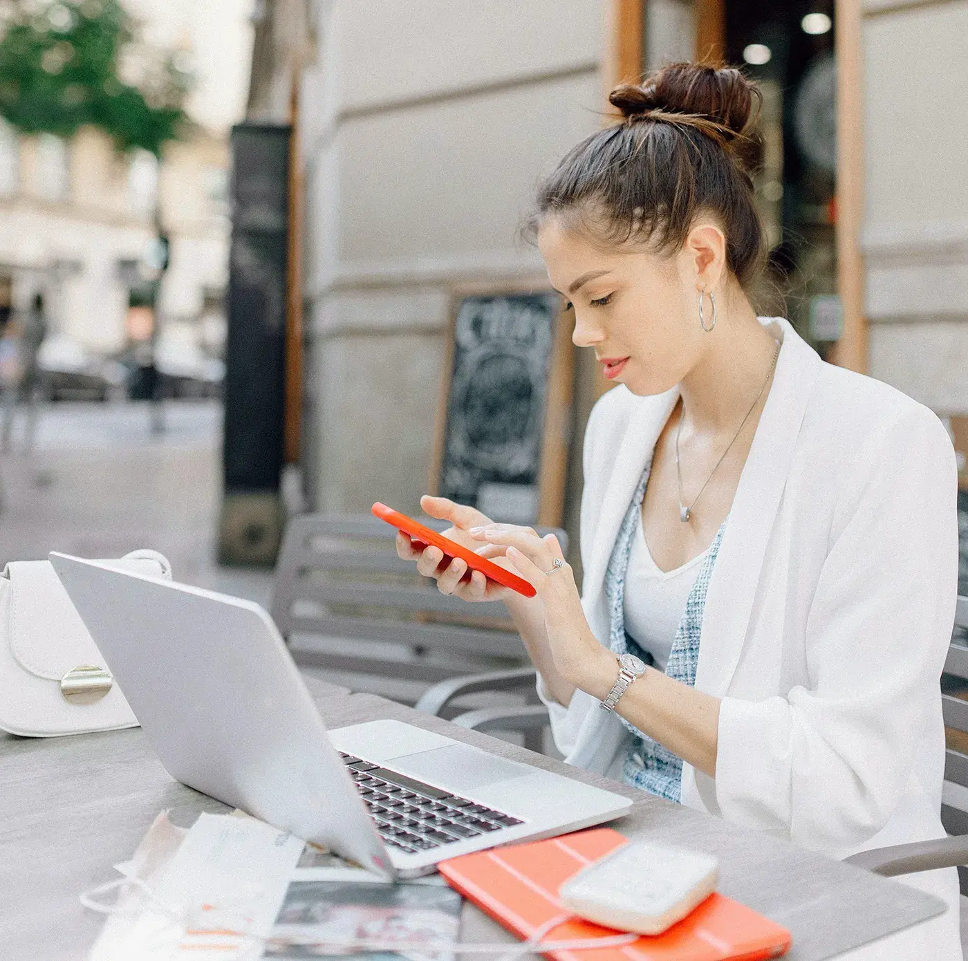 Woman working at cafe on her phone